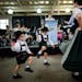 Stephanie De Sam Lazaro, right, with the Edelweiss Dancers, danced with her two sons, Michael, 4, left, and Andrew, 5, as The Bavarian Musikmeisters p