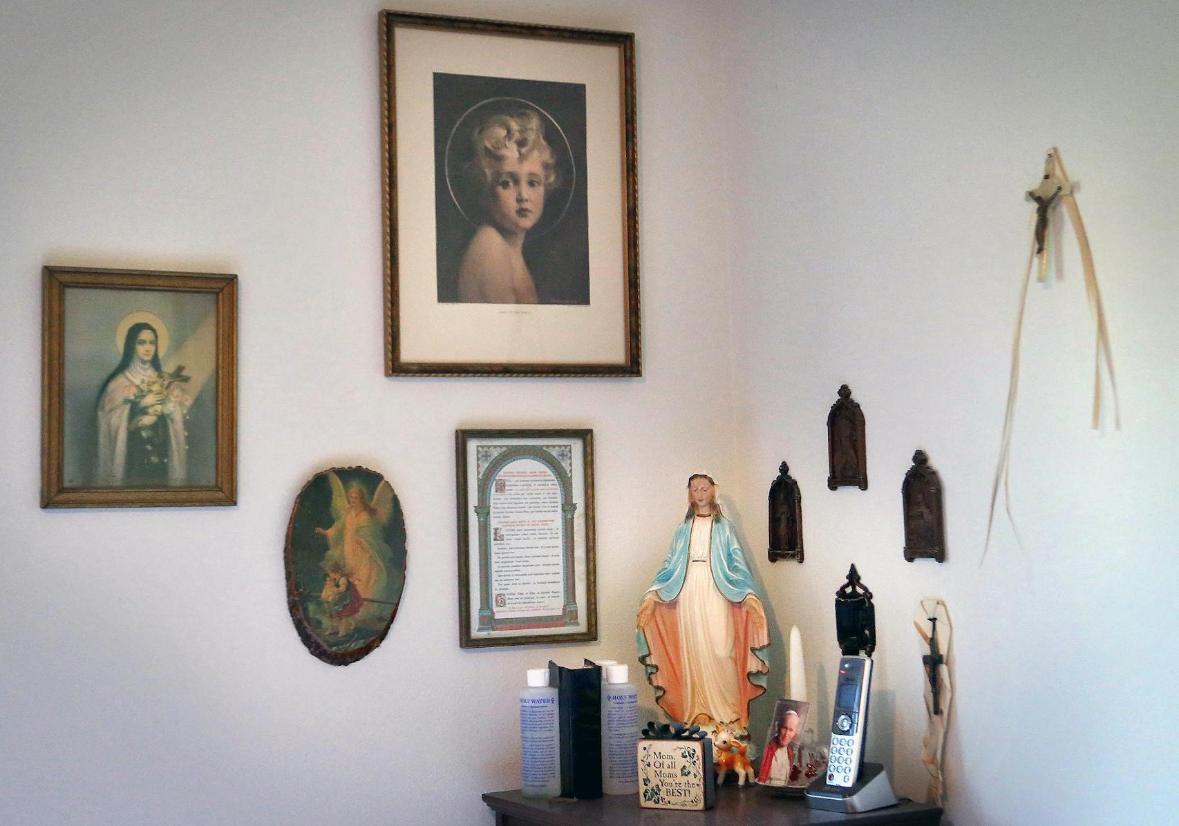 A corner of Grayce and Clayton Braaten's bedroom reflects Grayce's devotion to her Catholic faith. Clayton seeks comfort from their priest; he's urged Clayton to not let the tragedy consume his life. 