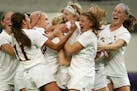 Maple Grove midfielder Meredith Haakenson, center, got a hug from Lexi Miller (18) as she was mobbed by her teammates after scoring the final goal in 