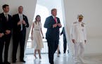 U.S. President Donald Trump and first lady Melania Trump, accompanied by Command Commander Adm. Harry Harris, right, participate in a wreath laying ce