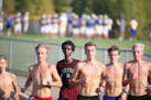 Khalid Hussein center (with shirt on) and Grant Price (far right ) and other members of the Wayzata high cross county team worked out at Wayzata High 