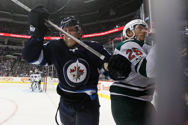 Winnipeg's Patrik Laine checked the Wild's Jonas Brodin during the second period on Friday night.