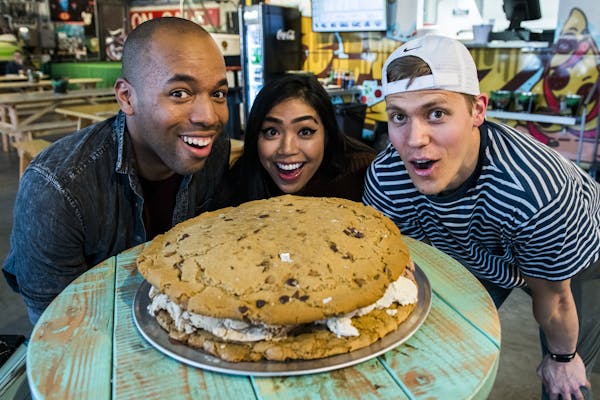 Local Instagram foodies (left to right) Lamar Roberts, Nikki Miraflor and Zach Vraa dig into the 15-pound ice cream sandwich at Seventh Street Truck P