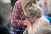 Longtime Minneapolis City Council Member Barb Johnson gave her sister, Therese VanBlarcom, a kiss on the hand after the first numbers came in at her c