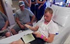 Tearful meeting for 2 linked by face transplant