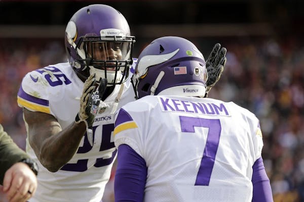 Minnesota Vikings running back Latavius Murray (25) and quarterback Case Keenum (7) celebrate a touchdown during an NFL football game against the Wash