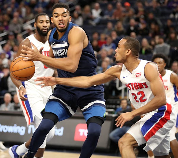 Karl-Anthony Towns of the Timberwolves worked against Detroit’s Avery Bradley (22) in Sunday’s loss to the Pistons.