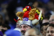 A Minnesota Vikings fan wears a turkey on his viking helmet during last year's Detroit Lions game in Detroit.