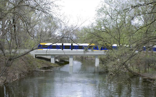 A rendering of the Southwest Light Rail train passing through the Kenilworth Lagoon