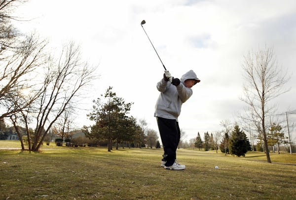Sometimes golf courses are open even in December. In this Dec. 19, 2011, photo, Mike Schneider, of St. Paul, Minn., golfs at Parkview Golf Club in Eag