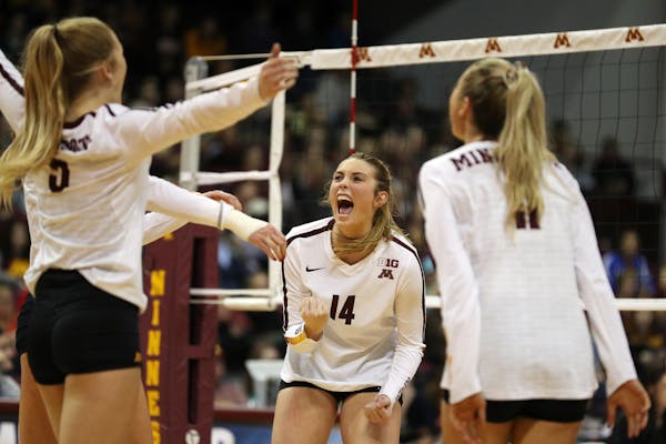 Gophers outside hitter Brittany McLean (14) celebrated a point with her teammates.