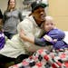 Near the end of the visit Diggs hugs Jack Taggart, 13, a cancer patient from Lakeville MN, during his visit to Children's as Jack's mom Sharri looks o