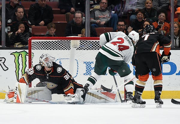Minnesota Wild defenseman Matt Dumba (24) scores on Anaheim Ducks goalie John Gibson during overtime of an NHL hockey game in Anaheim, Calif., Friday,