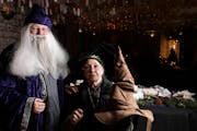 Reilona McVai as Albus Dumbledore and Gail Mason as Minerva McGonagall posed for a portrait with the sorting hat in the Great Hall.