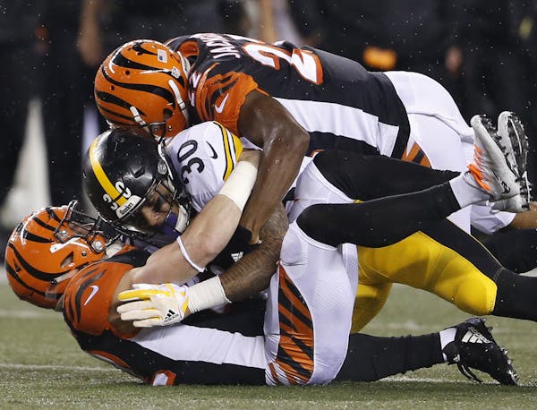Cornerback William Jackson, top, of the Bengals — the nastiest team in a nasty league — tackled Steelers running back James Conner two weeks ago.