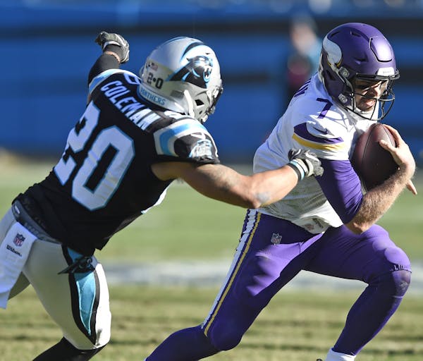 Minnesota Vikings' Case Keenum (7) runs past Carolina Panthers' Kurt Coleman (20) during the first half of an NFL football game in Charlotte, N.C., Su