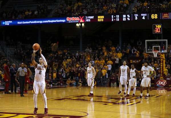 Minnesota Gophers guard Nate Mason (2) shot the first of four free throws after a second half foul combined with a technical foul on Rutgers. He finis