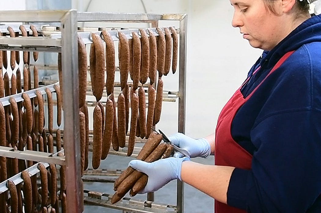 A worker at Conrath Quality Meats prepared bison snack sticks made from Northstar bison. They're free of MSG and sodium nitrite.