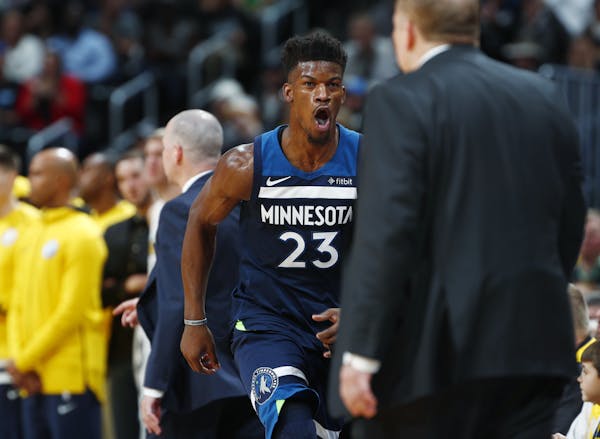 Minnesota Timberwolves guard Jimmy Butler (23) runs back to the bench and head coach Tom Thibodeau after hitting a key basket against the Denver Nugge
