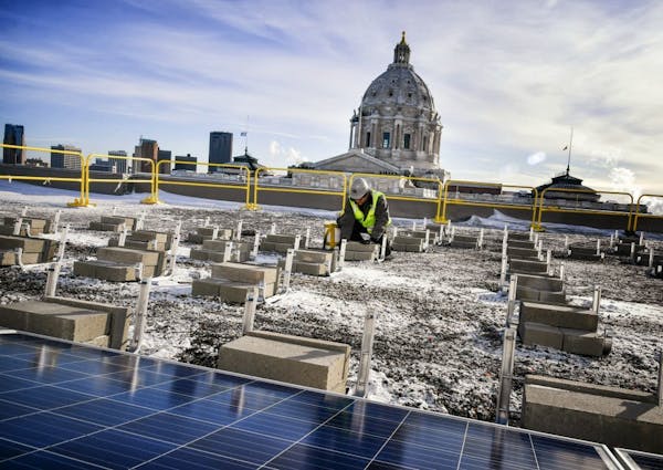 Crews began installing rooftop solar panels on the Minnesota Senate Building at the Capitol complex.