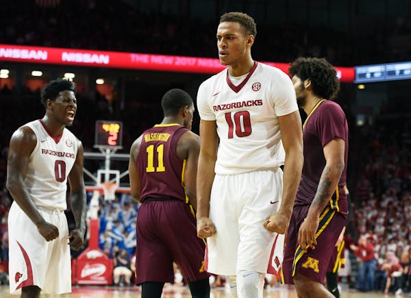 Arkansas' Jaylen Barford (0) and Daniel Gafford (10) react after a call during the second half of an NCAA college basketball game against Minnesota on