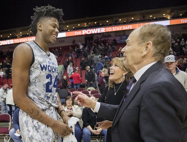 Timberwolves owner Glen Taylor and his wife, Becky, greeted Justin Patton at the end of the Iowa Wolves game Friday.