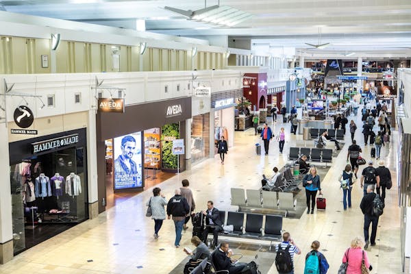 Air travelers pass through one of the main shopping areas in Terminal 1 at the Minneapolis-St. Paul International Airport. The airport remade its reta