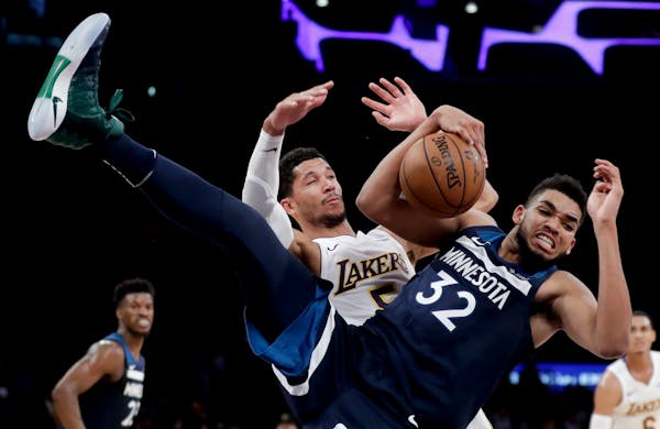Wolves center Karl-Anthony Towns battled Lakers guard Josh Hart for a rebound during the second half Monday. Towns finished with 21 points and 10 rebo