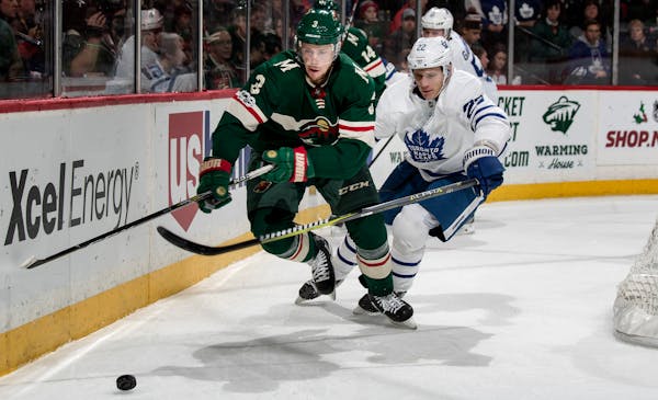 Charlie Coyle (3) and Nikita Zaitsev (22) chased the puck in the second period.