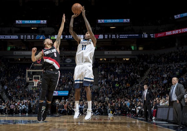 Jamal Crawford of the Timberwolves shot and scored over Al-Farouq Aminu of Portland in the fourth quarter Monday night.