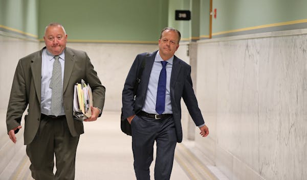 Stephen Frenz, right, and attorney Douglas Turner walked through City Hall in Minneapolis in September.