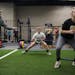 Strength and conditioning coach Josh Anderson, left, coached soccer player Devin Breeggemann and basketball player Courtney Freeberg, right, in a warm