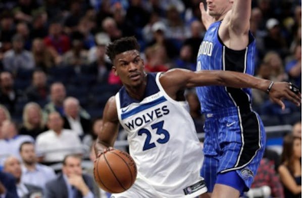 Wolves star Jimmy Butler (23) drives around Orlando Magic's Mario Hezonja during the first half of Tuesday's game.
