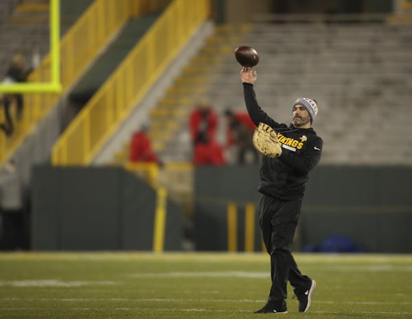 Minnesota Vikings quarterbacks coach Kevin Stefanski employs a first baseman’s glove to catch passes during warmups on Saturday, Dec. 23, 2017, at L