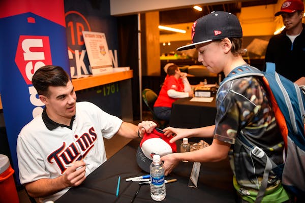 Twins pitcher Trevor May handed a signed hat back to Shepherd Ayshford, 12, of Anoka, during TwinsFest Saturday at Target Field. ] AARON LAVINSKY � 