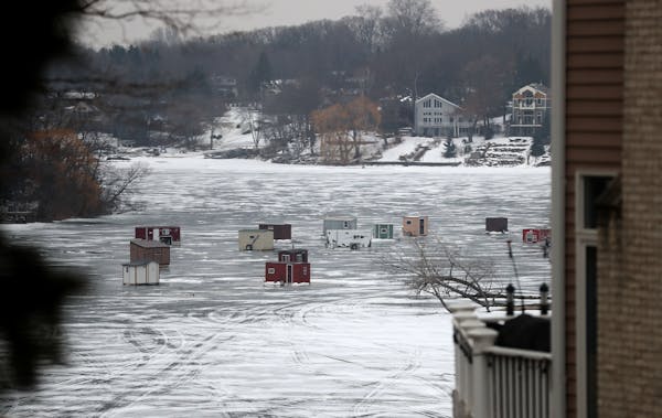 A cluster of ice fishing house is seen on lower Prior Lake on Wednesday