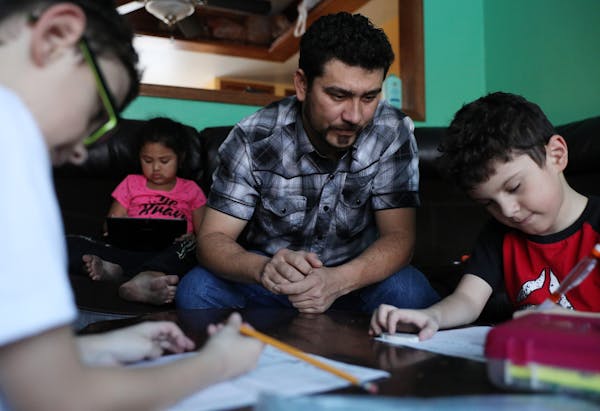 Santiago Portillo’s U.S.-born sons Luis Eduardo, left, and Luis Vicente did homework.