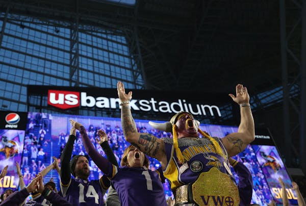 Minnesota Vikings fans, including Syd Davy, foreground, who dressed the part, erupt into an improvised "Skol!" chant as they leave U.S. Bank Stadium a