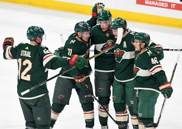 Minnesota Wild, from left, Eric Staal, Zach Parise, Charlie Coyle, Ryan Suter and Jared Spurgeon celebrate Spurgeon's goal in the first period of an N