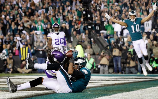 The Eagles' Alshon Jeffery caught a touchdown pass while being defended by Vikings cornerback Trae Waynes in the fourth quarter. ] CARLOS GONZALEZ �