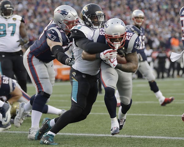 New England Patriots running back James White (28) runs against Jacksonville Jaguars linebacker Myles Jack (44) to the end zone for a touchdown during