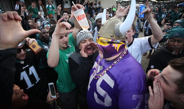 Vikings fan Andrew Grein walked through a crowd of hostile Eagle fans before kickoff of the NFC Championship Game at Lincoln Financial Field in Philad