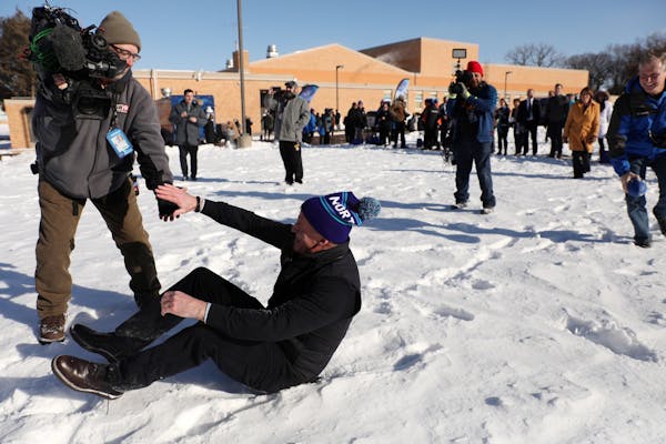 NFL Commissioner Roger Goodell was helped up by a Fox 9 photojournalist after he fell trying to catch a pass while playing with a group of students fo