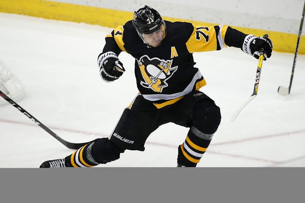 Pittsburgh Penguins' Evgeni Malkin (71) celebrates his goal during the first period of an NHL hockey game against the Minnesota Wild in Pittsburgh, Th