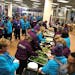 Crew 52 volunteers grab dinner during a break on Sunday. (photo by Eric Roper)