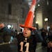A Philadelphia Eagles fan marches with a cone on his head in downtown Philadelphia as fans celebrate the team's victory in the NFL Super Bowl 52 footb