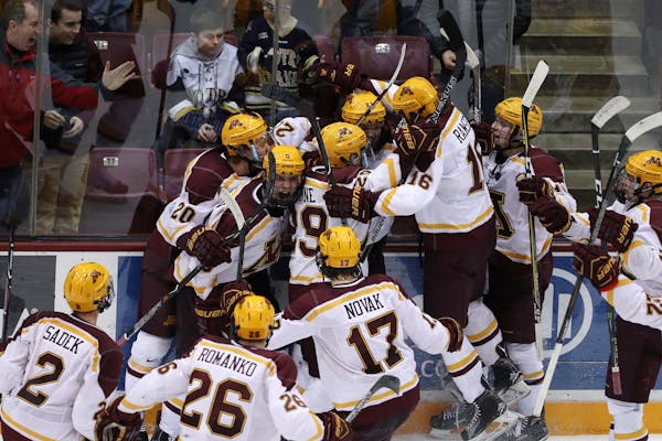 Gophers forward Casey Mittelstadt (21) was and his teammates celebrated an overtime win over Notre Dame last month.