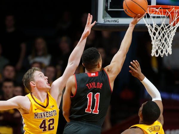 The Gophers' Michael Hurt (42) tried to block a layup by Nebraska's Evan Taylor at Williams Arena on Tuesday night.