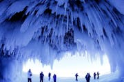 After trekking on frozen Lake Superior, visitors admire the striking Apostle Islands Ice Caves.