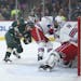 Rangers right wing Rick Nash (61) tried in vain to stop a bouncing puck shot by Minnesota Wild left wing Zach Parise (11).